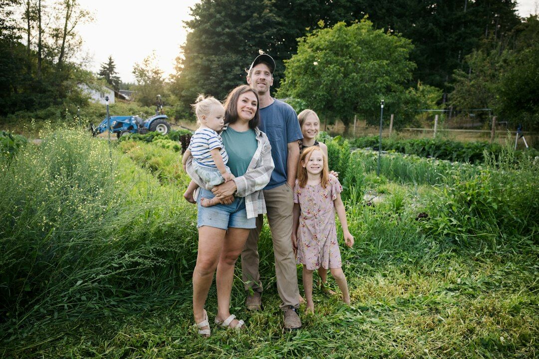 Danish farming family standing together in front of their family farm