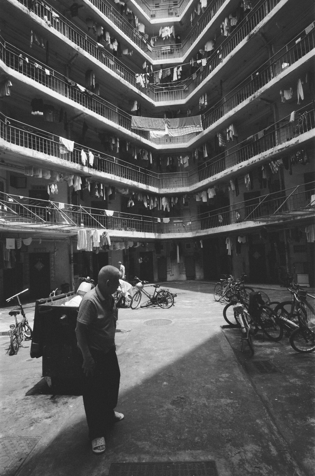 Neighbors chatting in a shared courtyard between Copenhagen apartment buildings